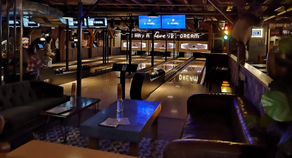 interior view of the bowling lanes and lounge eating areas at BNA Brewing in Kelowna, one of Kelowna's most unique restaurants – photo by Max Charp for Google Reviews